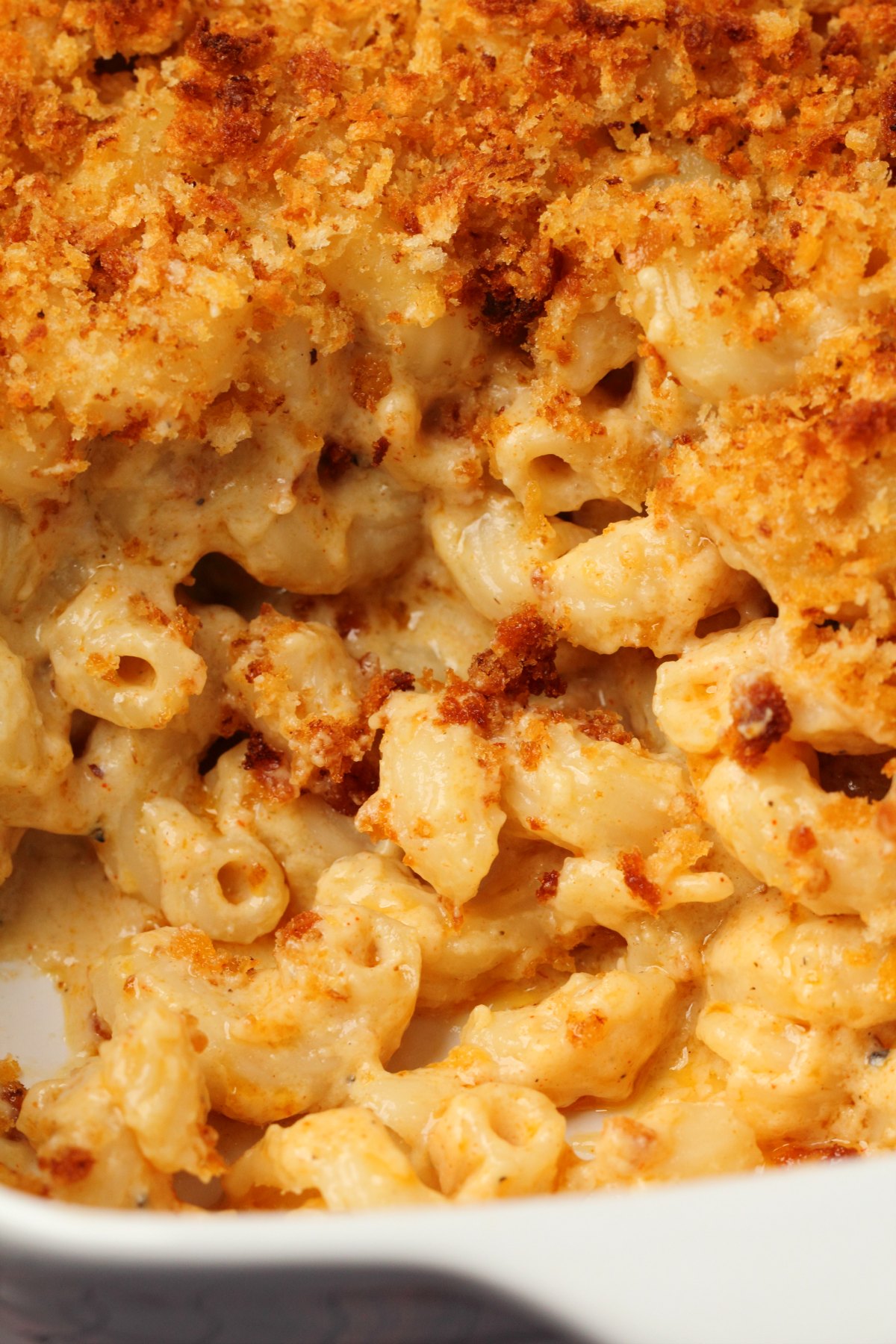 Baked vegan mac and cheese in a white dish. 