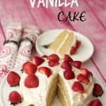 Vegan vanilla cake on a white cake stand.