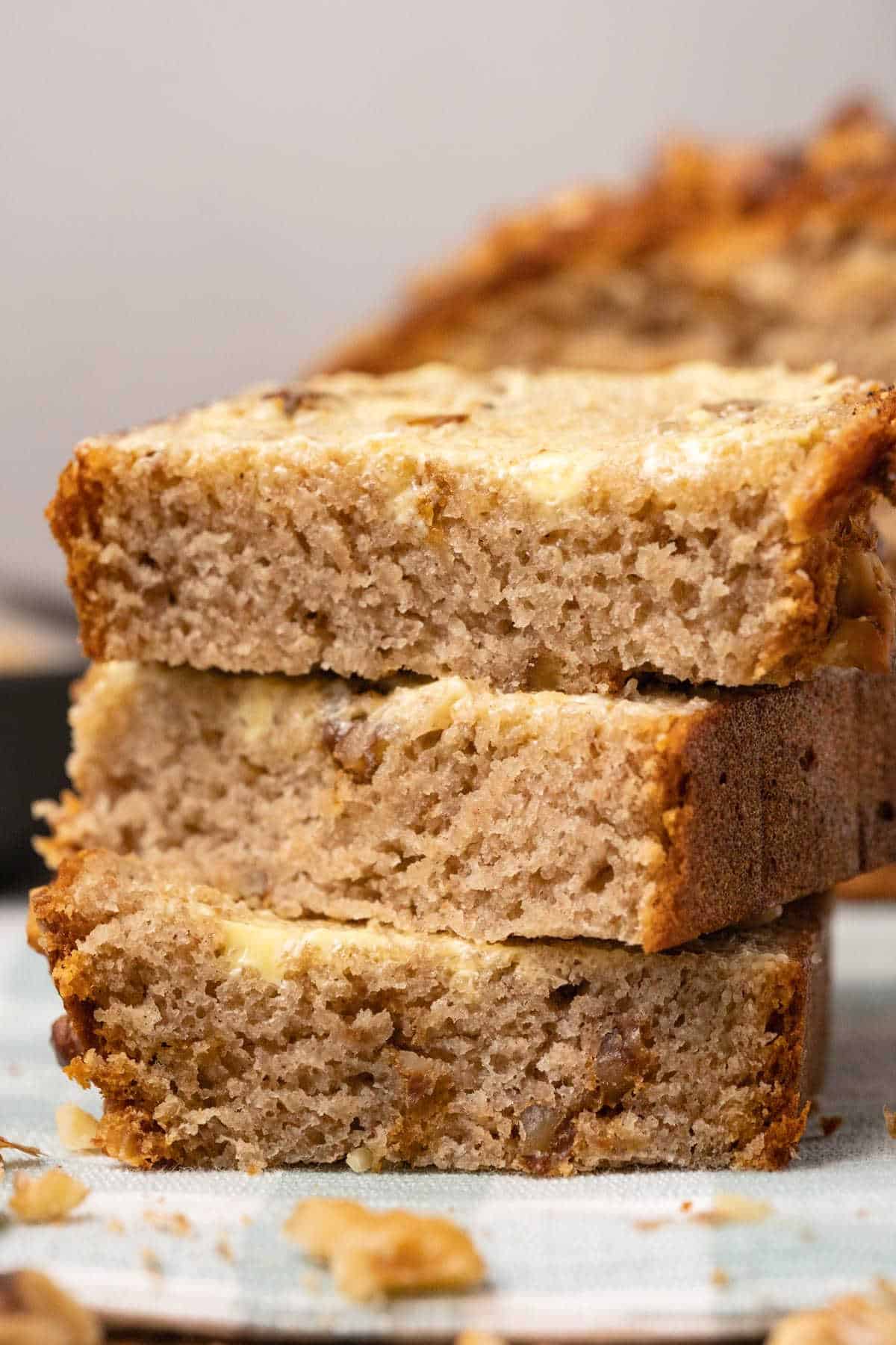 Buttered slices of banana bread in a stack. 