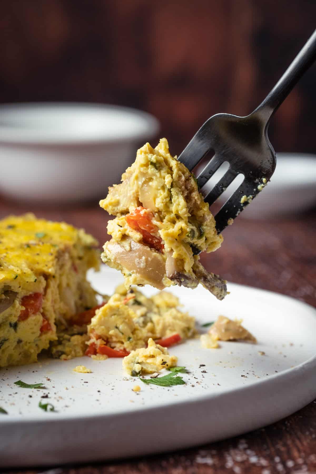 A bite of Vegan Breakfast Casserole on a black fork.