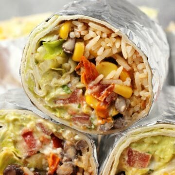 Vegan burritos stacked up on top of each other.