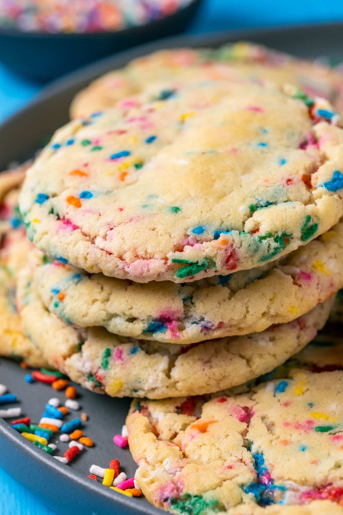 Vegan funfetti cookies in a stack an a gray plate.
