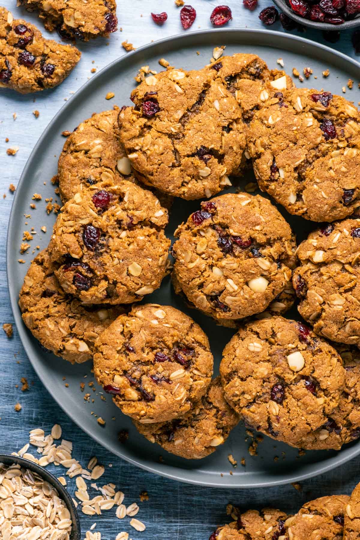 Vegan oatmeal cranberry cookies stacked up on a gray plate. 