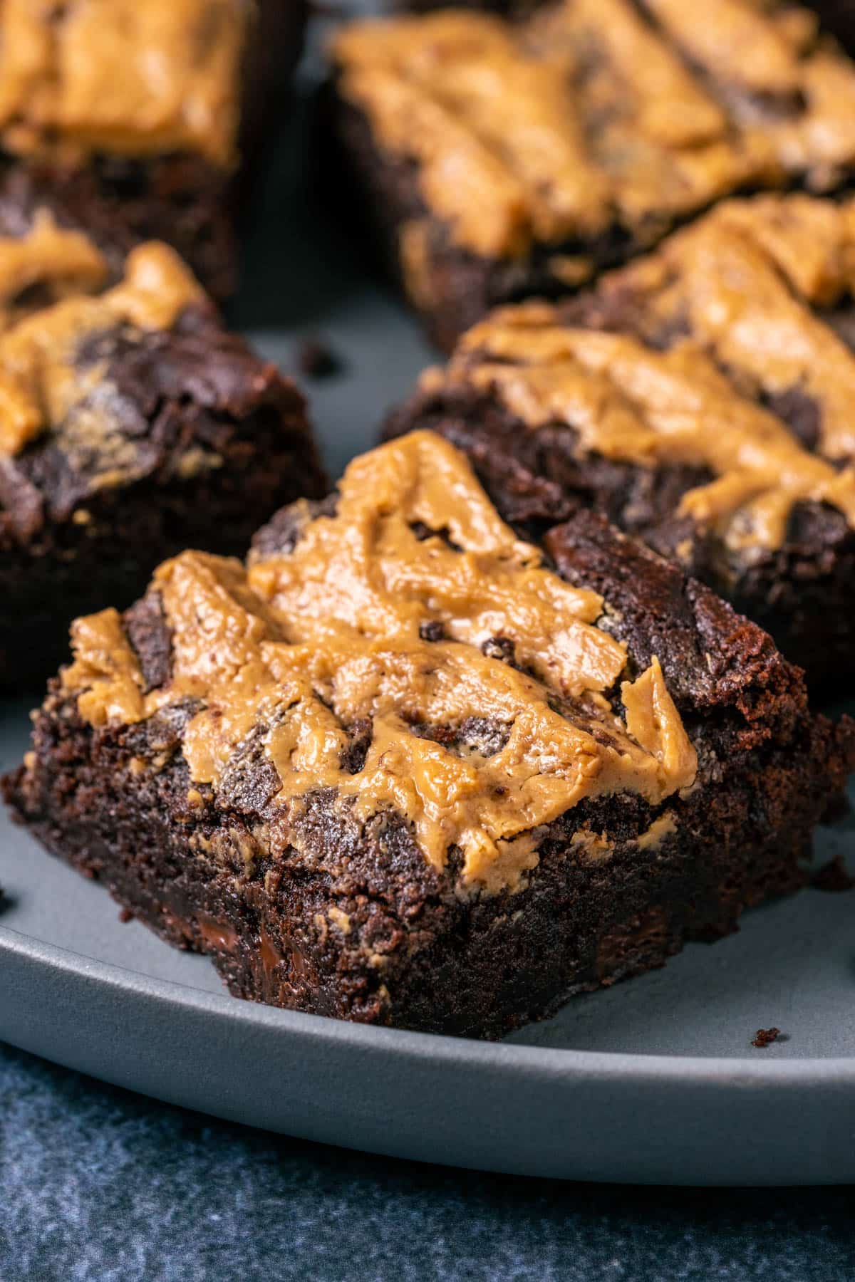 Peanut butter swirl brownies on a gray plate.