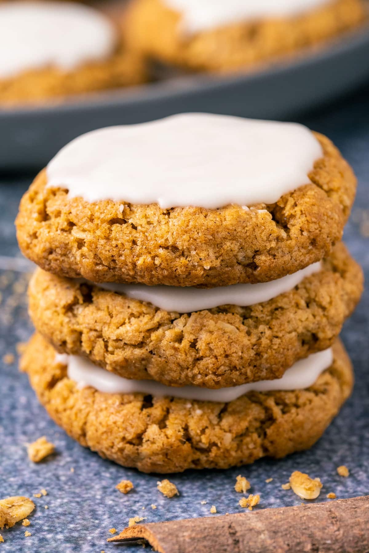 Stack of three frosted oatmeal cookies.