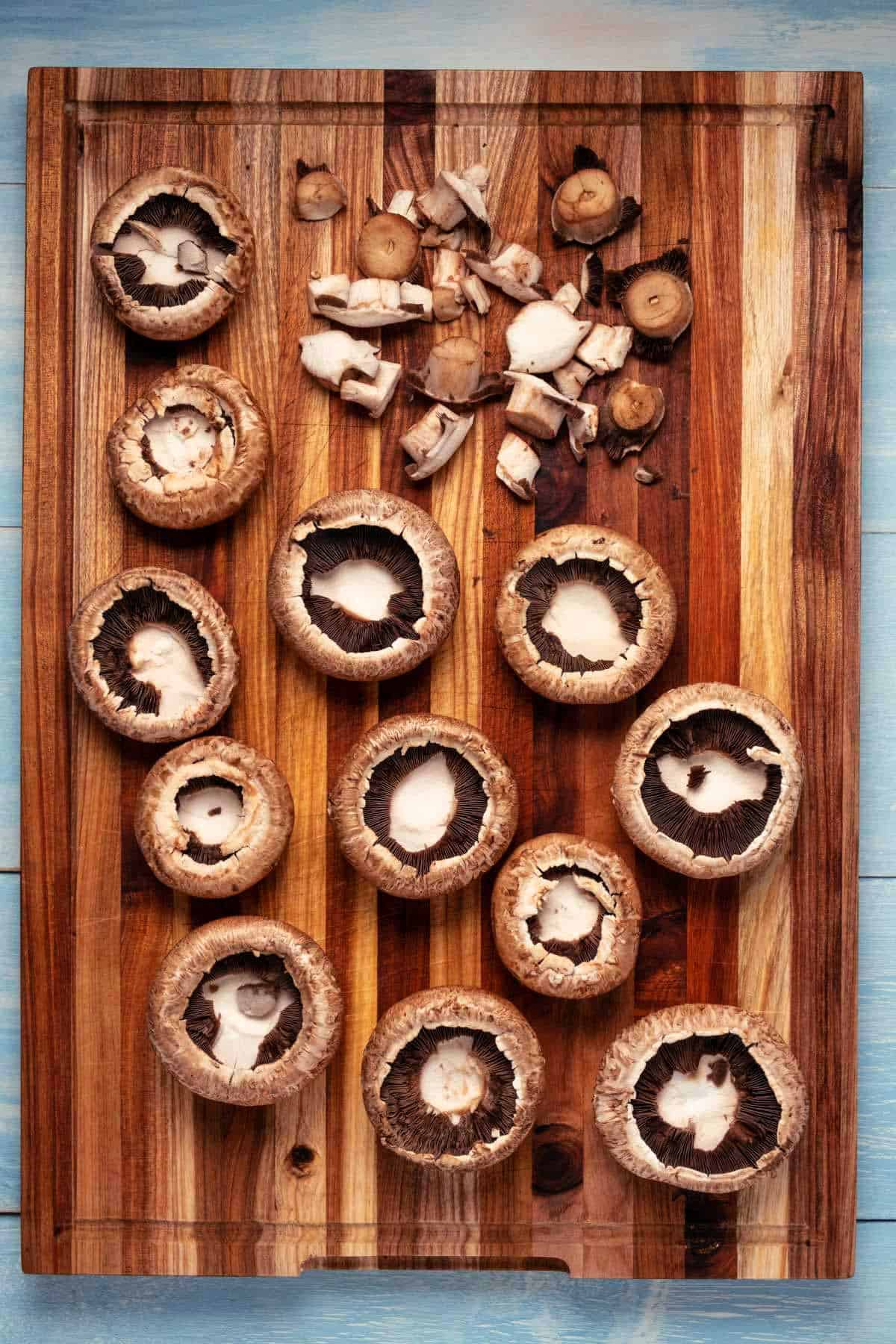 Large mushrooms on a wooden cutting board.